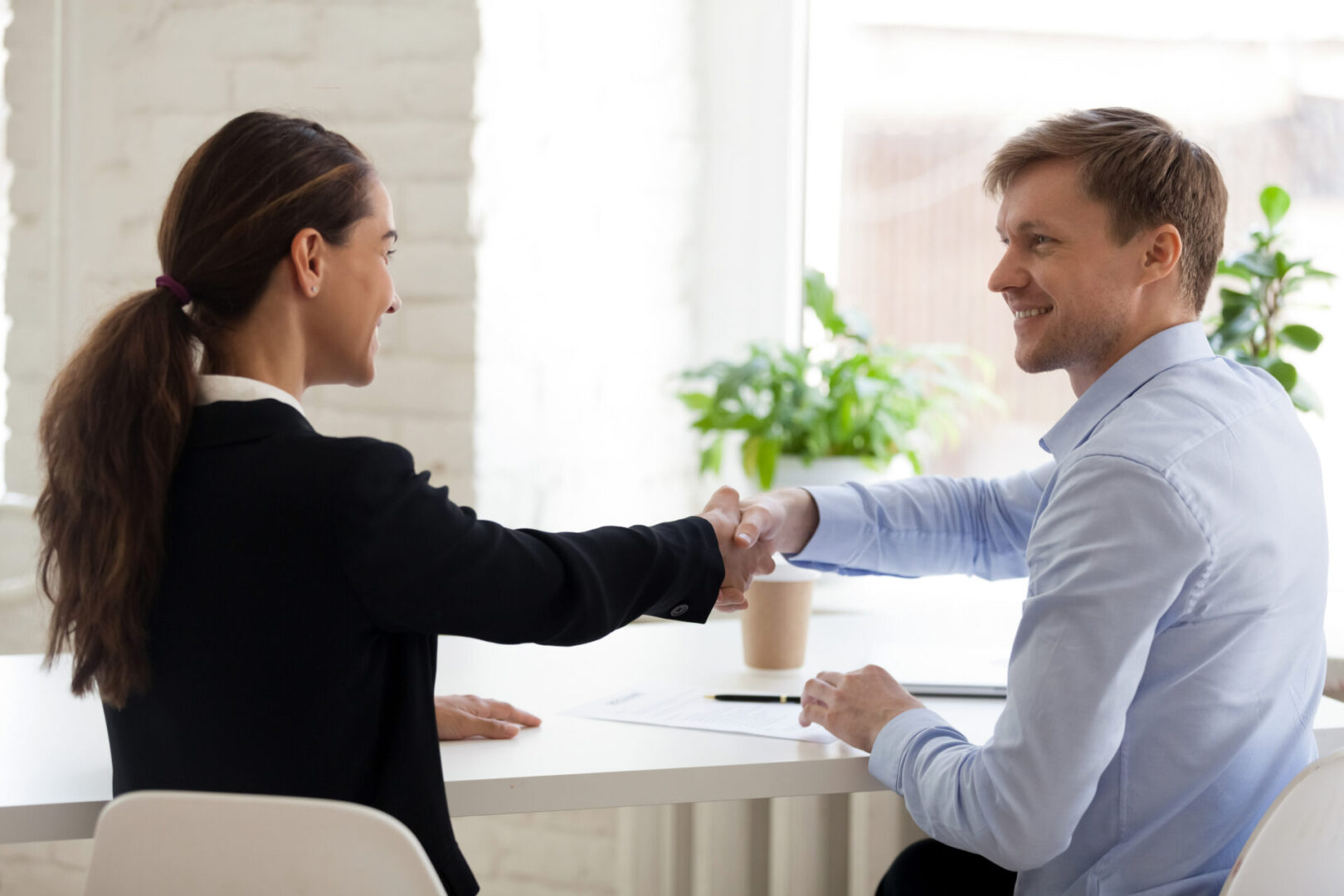 Business handshake in office setting