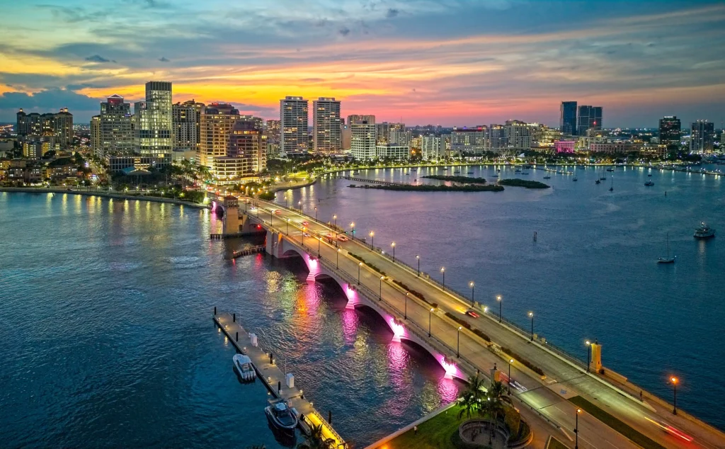 City skyline at sunset with illuminated bridge