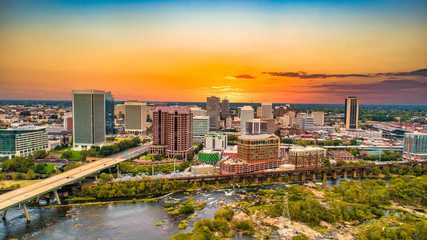 Sunset over riverfront city skyline with bridge