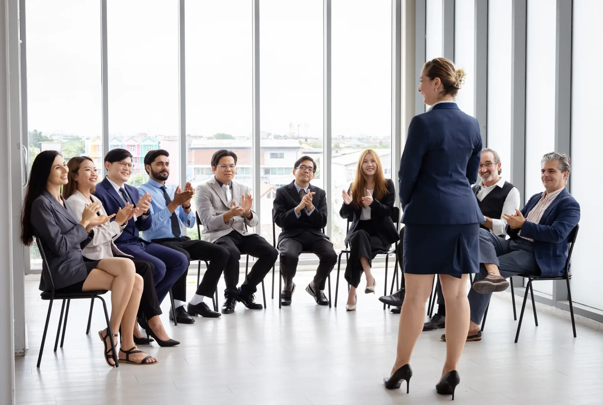 A business setting where an audience is applauding a speaker.