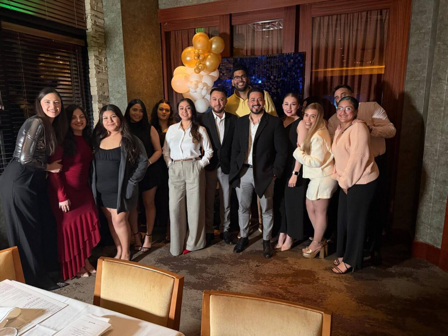 Group of friends at indoor celebration with balloons