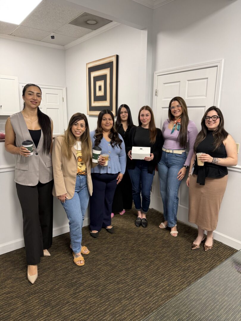 Group of seven women posing in office