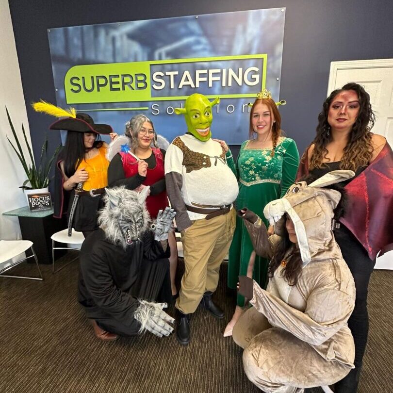 Group in fantasy costumes posing at staffing office